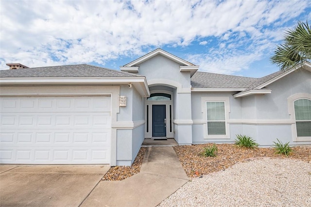 single story home with driveway, stucco siding, roof with shingles, and a garage
