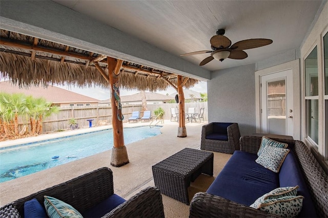 view of patio featuring ceiling fan, outdoor lounge area, a fenced in pool, and a fenced backyard