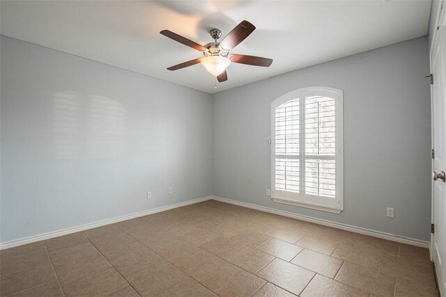 unfurnished room with baseboards, tile patterned floors, and ceiling fan