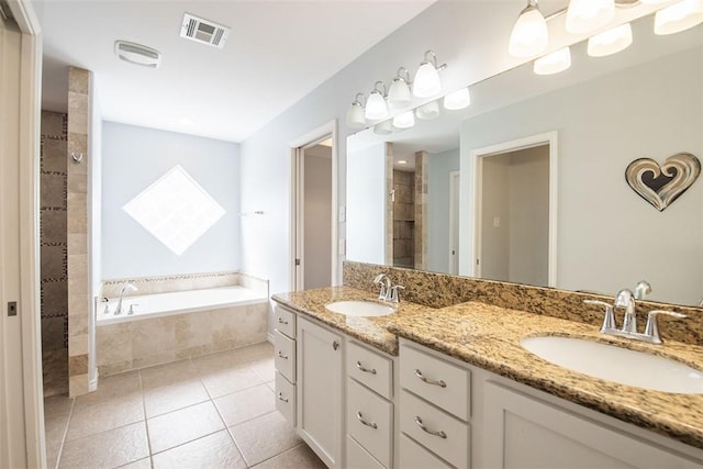 full bathroom with a sink, tile patterned flooring, visible vents, and a tile shower