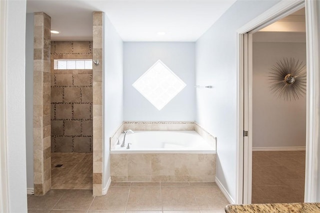 bathroom with a walk in shower, baseboards, a bath, and tile patterned flooring