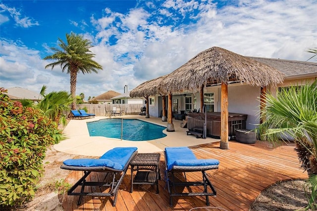 view of swimming pool featuring a deck, a hot tub, a fenced backyard, a patio area, and a fenced in pool