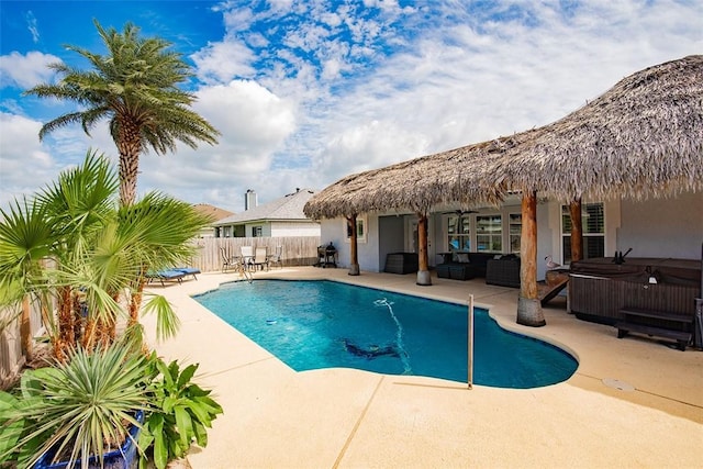 view of swimming pool featuring fence, a hot tub, an outdoor hangout area, a patio area, and a fenced in pool