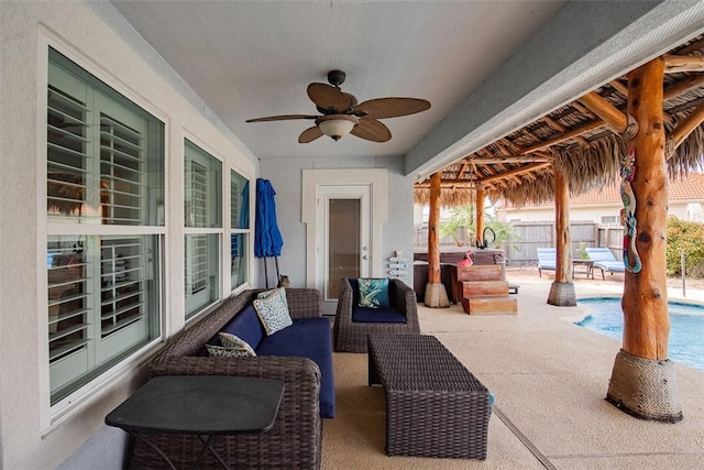 view of patio featuring an outdoor living space, fence, a fenced in pool, and a ceiling fan