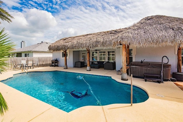 view of pool featuring a patio, a hot tub, a fenced in pool, and fence