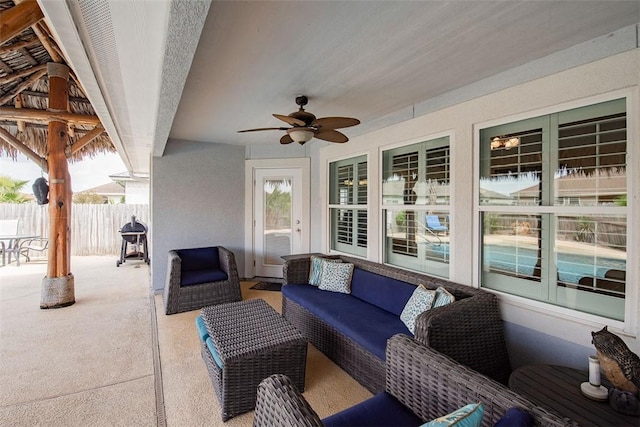 view of patio featuring an outdoor hangout area, fence, and a ceiling fan