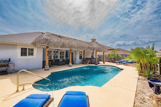 view of swimming pool featuring fence, a patio, an outdoor living space, ceiling fan, and a jacuzzi