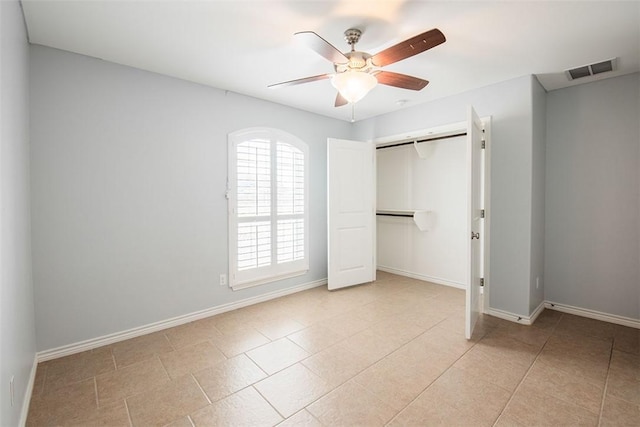 unfurnished bedroom featuring baseboards, ceiling fan, a closet, and visible vents