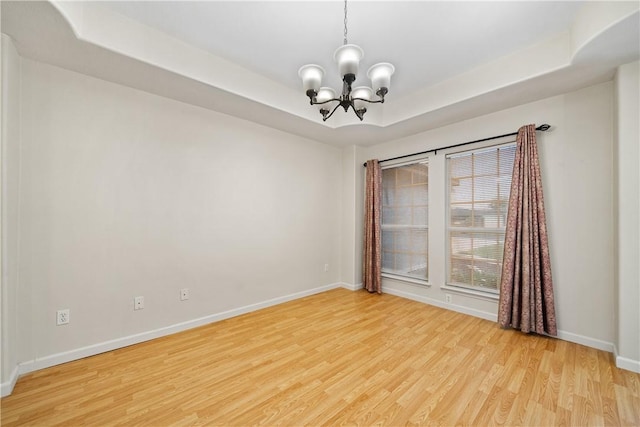 3606 Emory Dr, Corpus Christi, TX 78410 - unfurnished room with a chandelier, light wood-style flooring, and a tray ceiling