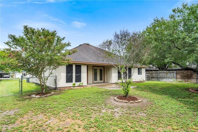 3606 Emory Dr, Corpus Christi, TX 78410 - back of house with french doors, a gate, stucco siding, a fenced backyard, and roof with shingles