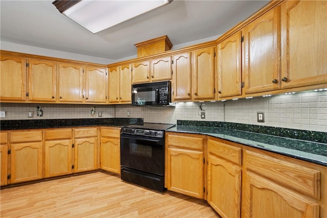 3606 Emory Dr, Corpus Christi, TX 78410 - kitchen featuring black appliances, tasteful backsplash, light wood-style floors, and dark stone countertops