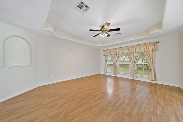 3606 Emory Dr, Corpus Christi, TX 78410 - empty room featuring a tray ceiling, ceiling fan, and light wood-type flooring