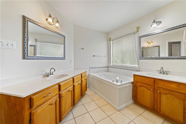 3606 Emory Dr, Corpus Christi, TX 78410 - bathroom with two vanities, tile patterned flooring, and a garden tub