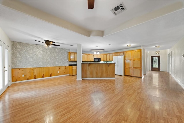 3606 Emory Dr, Corpus Christi, TX 78410 - unfurnished living room featuring ceiling fan, light wood-style floors, and a wainscoted wall
