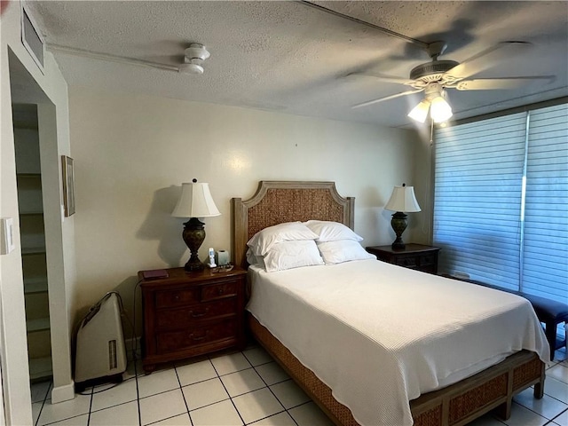 4242 Gulfbreeze Blvd Unit 606, Corpus Christi, TX 78402 - bedroom with light tile patterned flooring, ceiling fan, and a textured ceiling