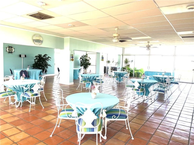 4242 Gulfbreeze Blvd Unit 606, Corpus Christi, TX 78402 - dining space with a ceiling fan, a paneled ceiling, and tile patterned floors