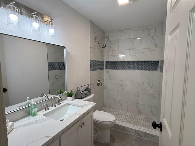 2413 Still Brook Dr, Corpus Christi, TX 78414 - bathroom featuring toilet, tiled shower, vanity, and a textured wall