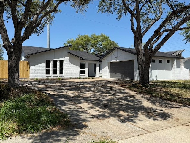 2413 Still Brook Dr, Corpus Christi, TX 78414 - view of front facade with concrete driveway, a garage, fence, and brick siding