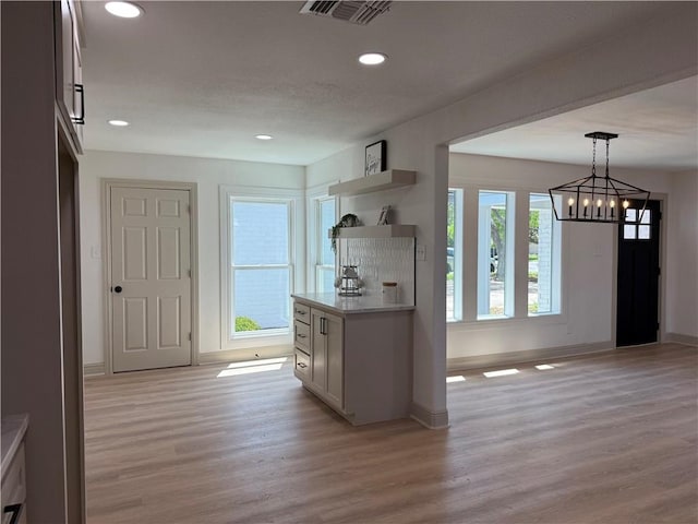 2413 Still Brook Dr, Corpus Christi, TX 78414 - kitchen featuring light wood-style flooring, open shelves, visible vents, light countertops, and a notable chandelier