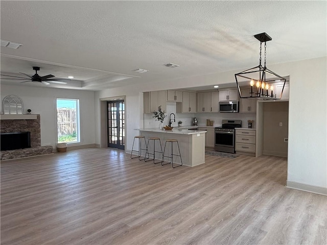 2413 Still Brook Dr, Corpus Christi, TX 78414 - kitchen with a sink, open floor plan, light countertops, appliances with stainless steel finishes, and light wood finished floors