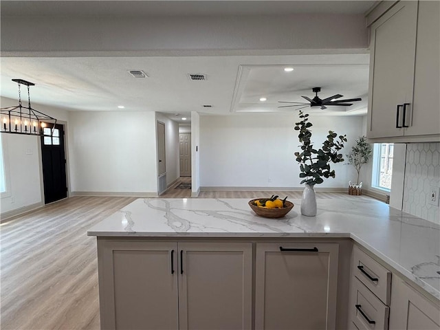 2413 Still Brook Dr, Corpus Christi, TX 78414 - kitchen featuring light wood-style floors, pendant lighting, light stone countertops, visible vents, and recessed lighting
