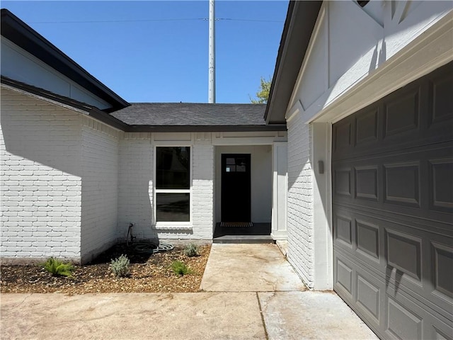 2413 Still Brook Dr, Corpus Christi, TX 78414 - property entrance featuring roof with shingles, a garage, and brick siding