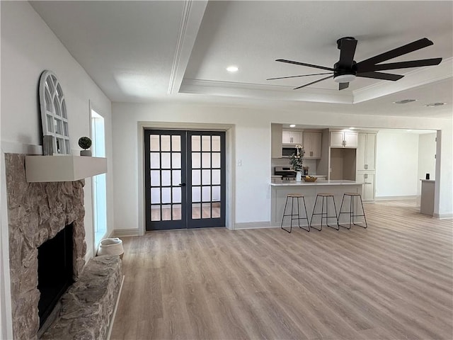 2413 Still Brook Dr, Corpus Christi, TX 78414 - living room with a tray ceiling, light wood-type flooring, baseboards, and a ceiling fan