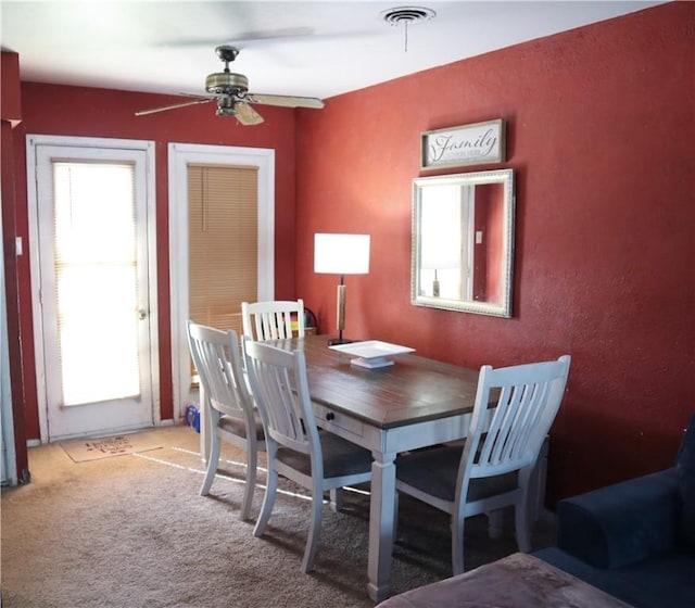 4625 Mildred Dr, Corpus Christi, TX 78411 - dining area featuring visible vents, ceiling fan, and light carpet