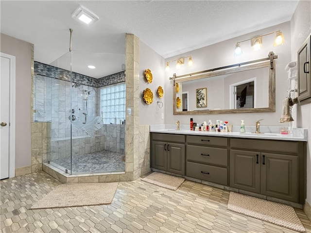 13910 Riverway Dr, Corpus Christi, TX 78410 - bathroom with double vanity, a stall shower, and tile patterned flooring