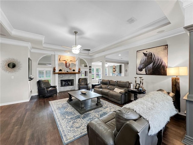 13910 Riverway Dr, Corpus Christi, TX 78410 - living room with a raised ceiling, a ceiling fan, a fireplace, dark wood-style floors, and crown molding