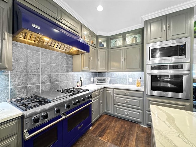 13910 Riverway Dr, Corpus Christi, TX 78410 - kitchen with stainless steel appliances, range hood, gray cabinets, light stone counters, and ornamental molding