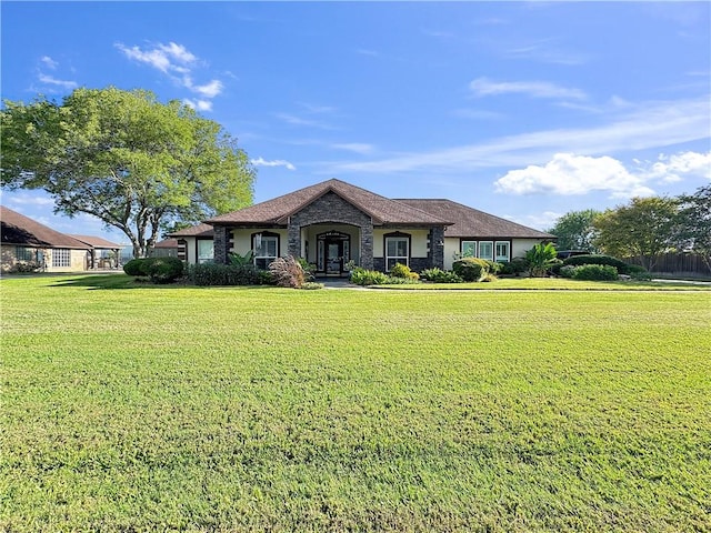 13910 Riverway Dr, Corpus Christi, TX 78410 - view of front of property with a front lawn and stone siding