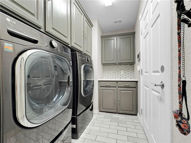 13910 Riverway Dr, Corpus Christi, TX 78410 - laundry area with cabinet space and washer and clothes dryer