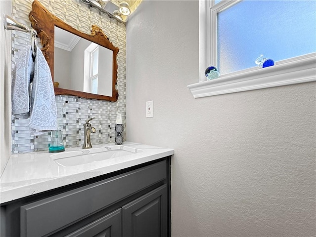 13910 Riverway Dr, Corpus Christi, TX 78410 - bathroom featuring decorative backsplash, vanity, crown molding, and a textured wall