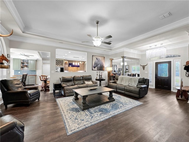 13910 Riverway Dr, Corpus Christi, TX 78410 - living area featuring a ceiling fan, a raised ceiling, dark wood-style flooring, ornamental molding, and ornate columns