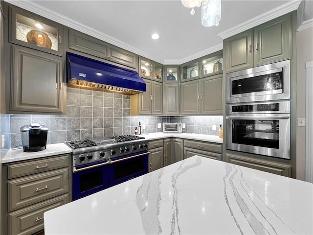 13910 Riverway Dr, Corpus Christi, TX 78410 - kitchen with stainless steel appliances, premium range hood, backsplash, glass insert cabinets, and light stone counters