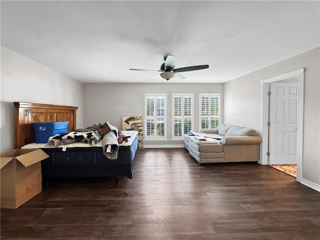 13910 Riverway Dr, Corpus Christi, TX 78410 - bedroom with dark wood-style flooring, a ceiling fan, and a textured ceiling