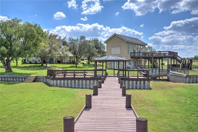 back of property featuring a lawn and a gazebo