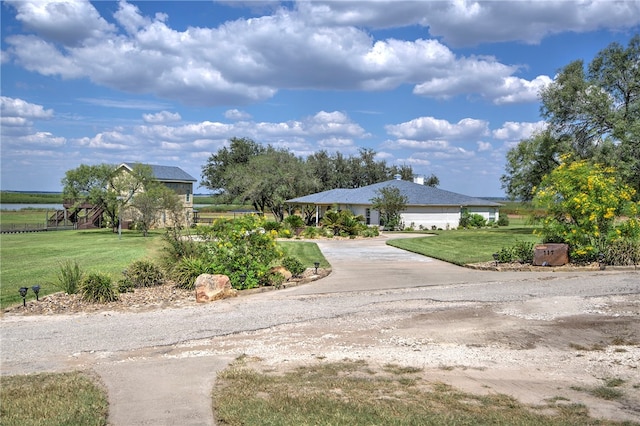 view of home's community with a yard