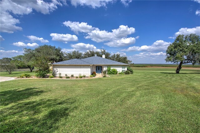 view of front of home with a garage and a front yard