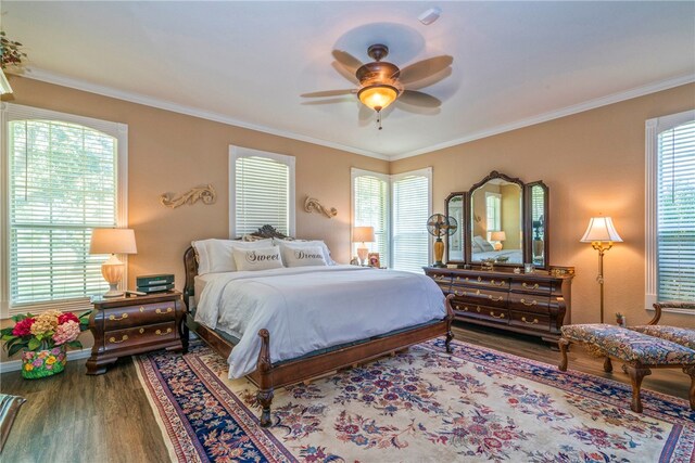 bedroom with ornamental molding, multiple windows, wood-type flooring, and ceiling fan