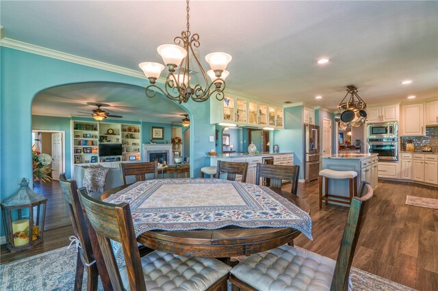 dining space with dark hardwood / wood-style flooring, ceiling fan with notable chandelier, and crown molding