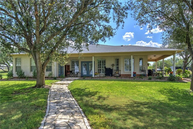 view of front of property featuring french doors and a front lawn