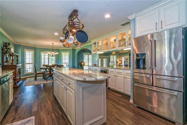 kitchen featuring white cabinets, stainless steel appliances, a kitchen island, and dark hardwood / wood-style flooring