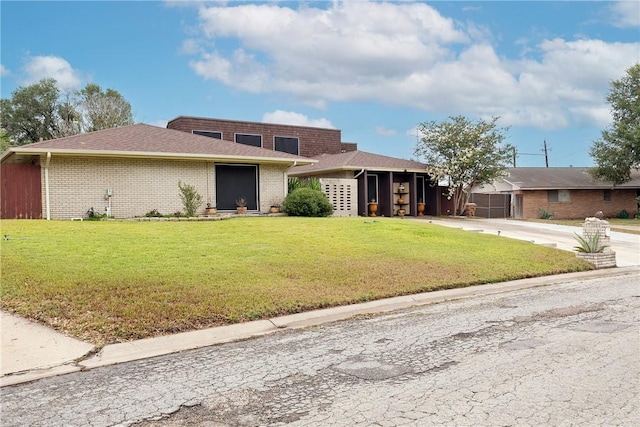 11157 Jackson Ter, Corpus Christi, TX 78410 - view of front of property with a front lawn, brick siding, and driveway