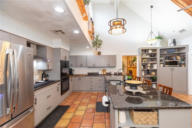 11157 Jackson Ter, Corpus Christi, TX 78410 - kitchen with black appliances, gray cabinets, tasteful backsplash, a breakfast bar, and hanging light fixtures