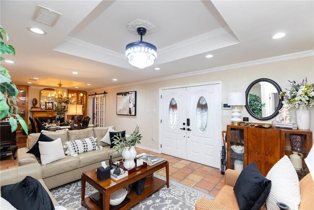 11157 Jackson Ter, Corpus Christi, TX 78410 - living room with a chandelier, a raised ceiling, recessed lighting, ornamental molding, and stone tile flooring