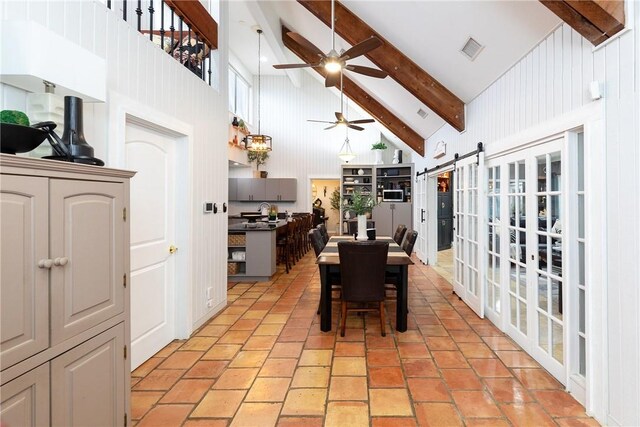 11157 Jackson Ter, Corpus Christi, TX 78410 - dining room with high vaulted ceiling, a ceiling fan, beamed ceiling, and a barn door