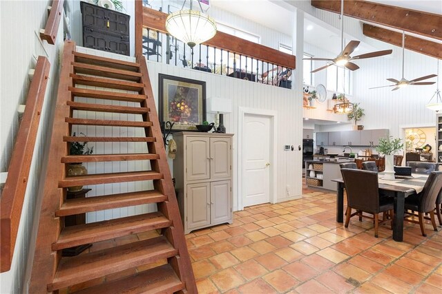 11157 Jackson Ter, Corpus Christi, TX 78410 - dining room with high vaulted ceiling, stairs, ceiling fan, beam ceiling, and light tile patterned floors