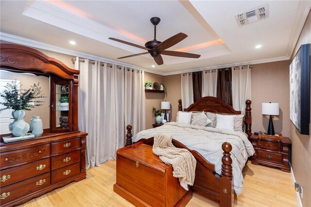 11157 Jackson Ter, Corpus Christi, TX 78410 - bedroom with a raised ceiling, light wood-style floors, ornamental molding, recessed lighting, and a ceiling fan